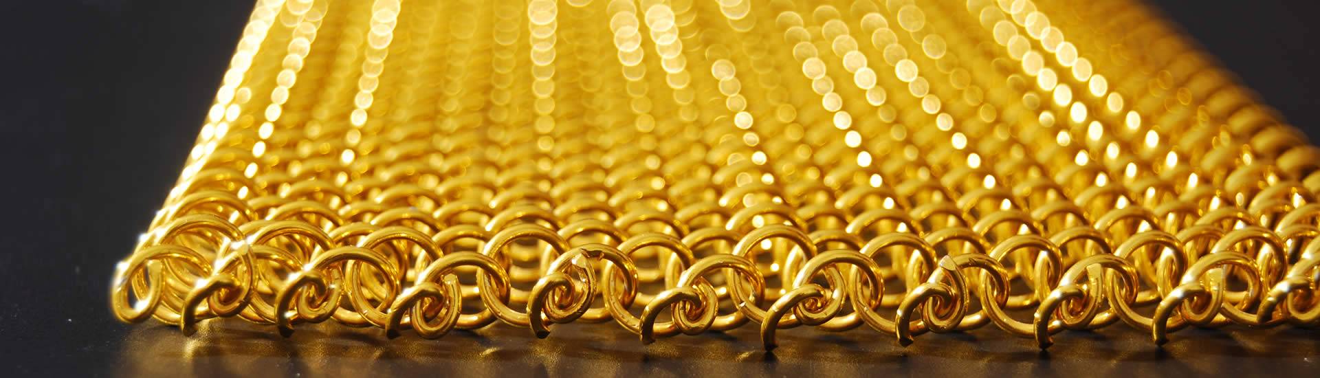 Details about edge of golden metal coil drapery.